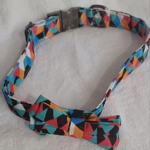 Fancy dog collar with bow, adjustable to fit medium and large dogs.